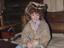 Katelyn in buckskin and racoon hat in Fort Clatsup